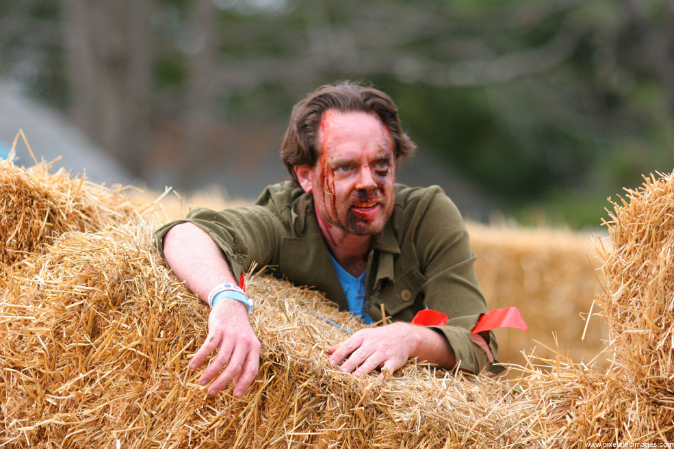 A zombie waits for more runners in the maze obstacle of Run For Your Lives 2011